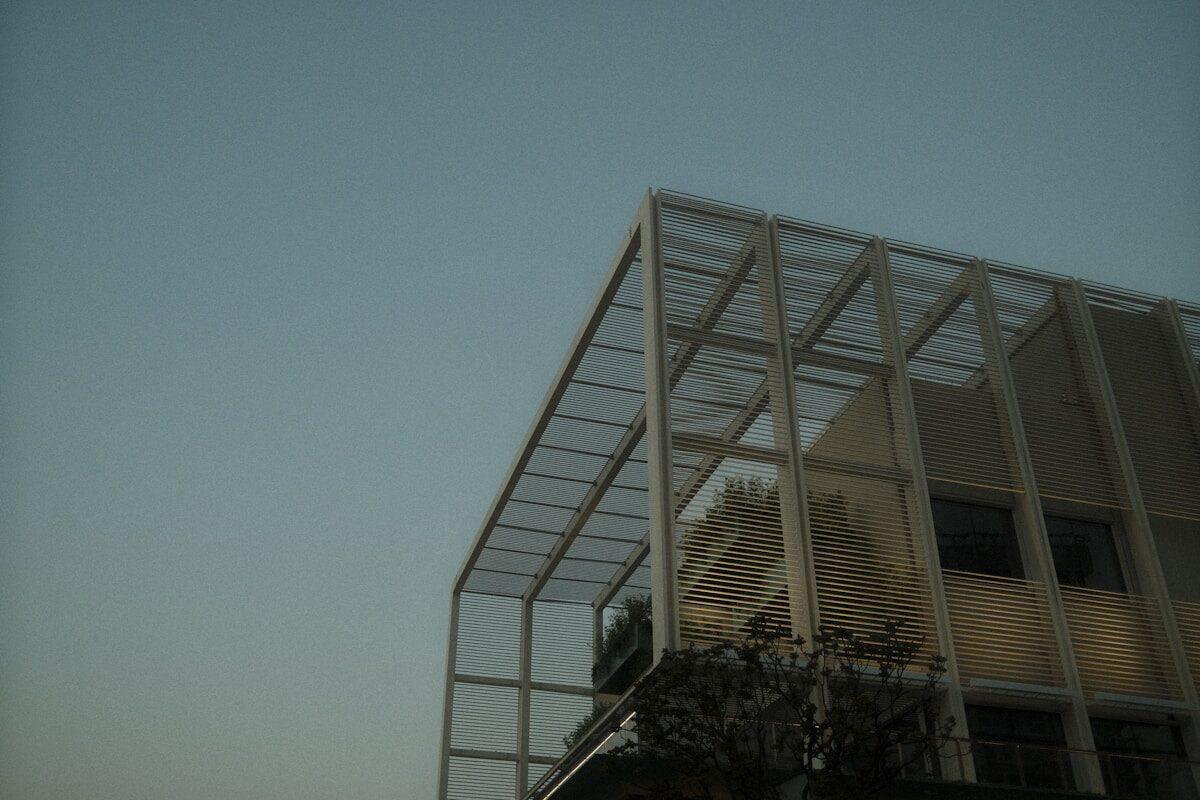 Modern building with geometric framework against sky